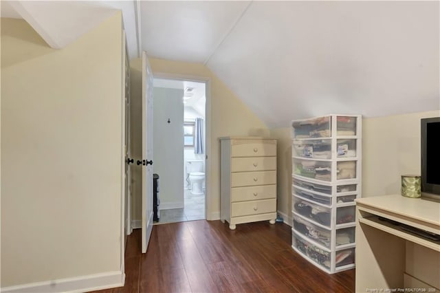 additional living space featuring dark hardwood / wood-style flooring and vaulted ceiling