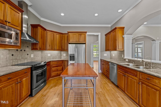 kitchen with a healthy amount of sunlight, sink, light hardwood / wood-style flooring, and appliances with stainless steel finishes