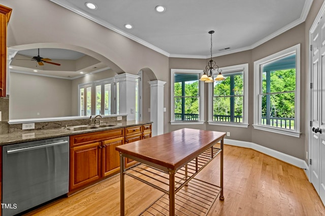 kitchen featuring sink, dark stone counters, decorative light fixtures, light wood-type flooring, and dishwasher