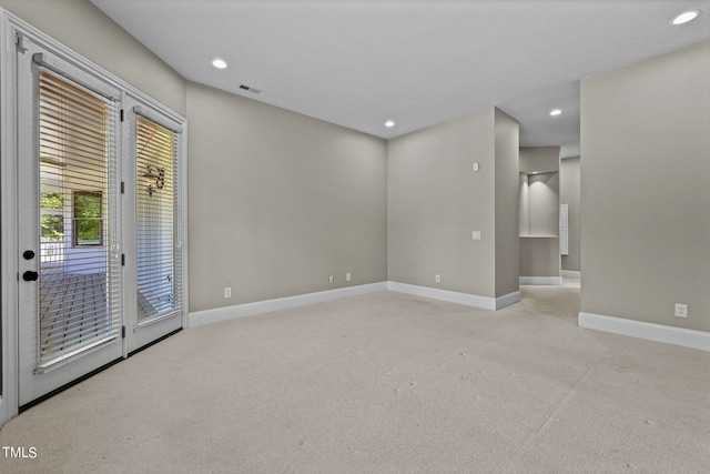 unfurnished room featuring light colored carpet