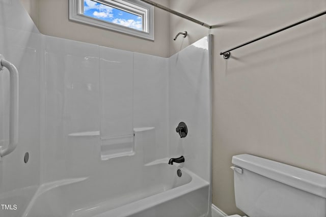 bathroom featuring shower / bathing tub combination and toilet