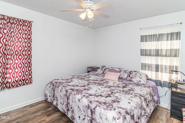 bedroom featuring dark hardwood / wood-style flooring and ceiling fan