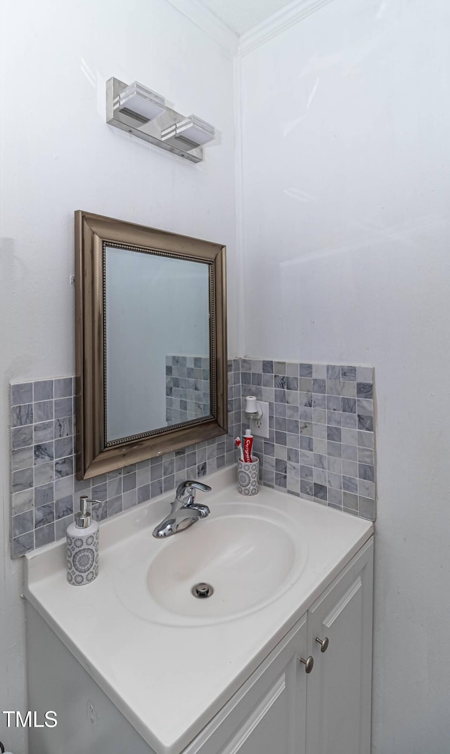 bathroom with vanity, tasteful backsplash, and crown molding