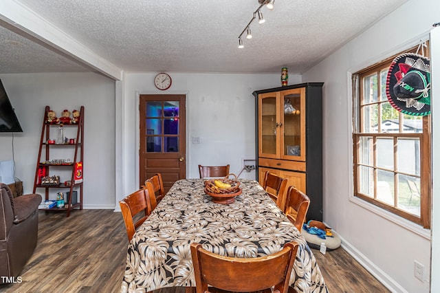 dining space with a textured ceiling and dark wood-type flooring