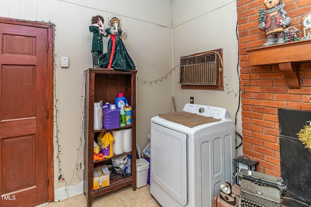 laundry area featuring washer / clothes dryer, a fireplace, light tile patterned flooring, and a wall mounted air conditioner