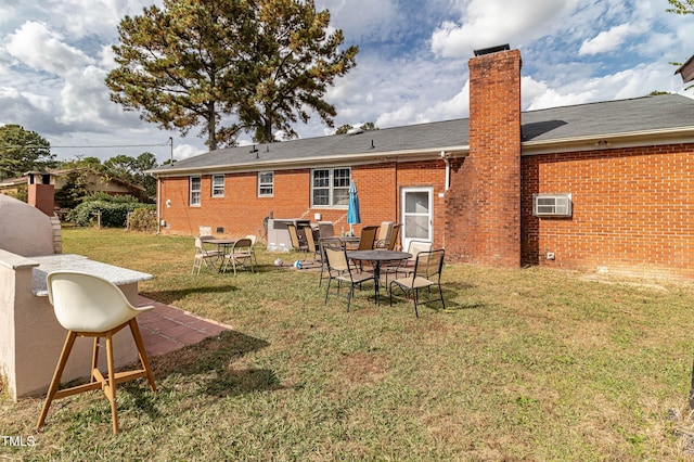 1717 Martin Luther King Dr, Rocky Mount, NC 27801 - rear view of house with a chimney, brick siding, a yard, and a patio area