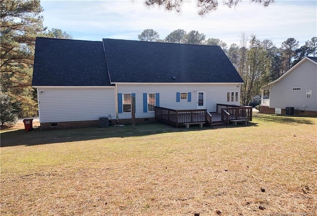 rear view of property featuring a lawn, a wooden deck, and central AC