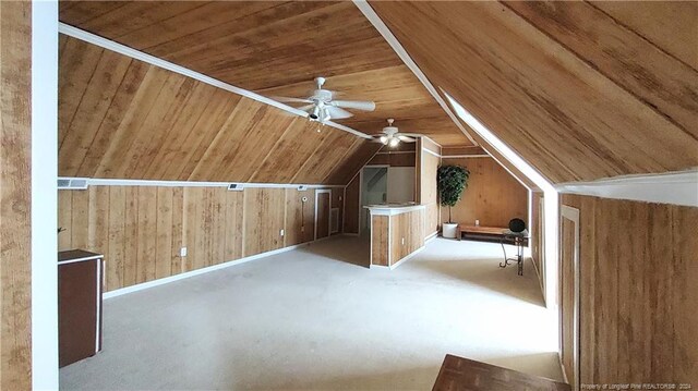 bonus room with light carpet, wooden walls, vaulted ceiling, wooden ceiling, and ceiling fan