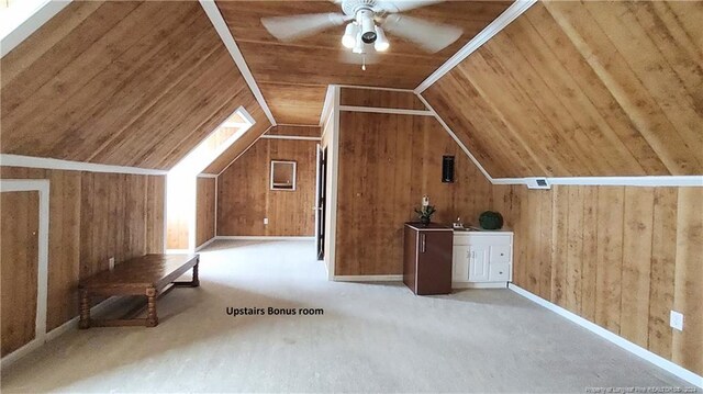 additional living space featuring sink, ceiling fan, wood ceiling, lofted ceiling, and wooden walls