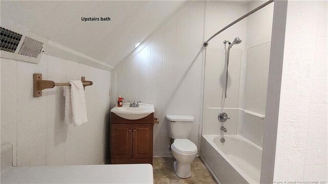 full bathroom with vanity, wooden walls, shower / bath combination, vaulted ceiling, and toilet