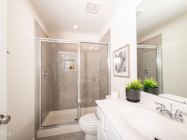 bathroom featuring walk in shower, tile patterned floors, vanity, and toilet