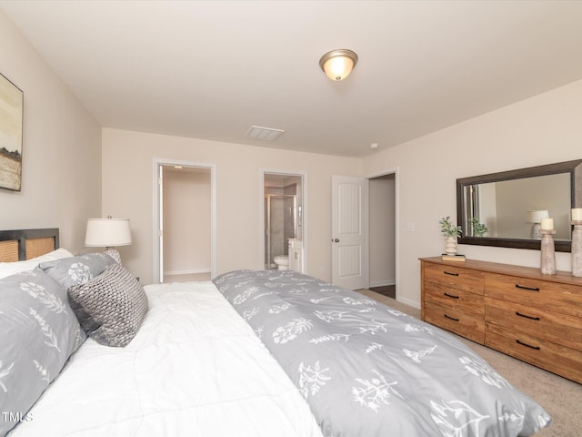 carpeted bedroom with ensuite bath