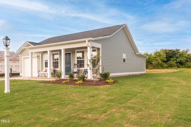 view of front of house featuring a garage, covered porch, and a front yard