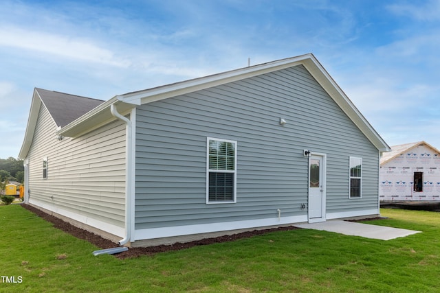 rear view of house with a lawn