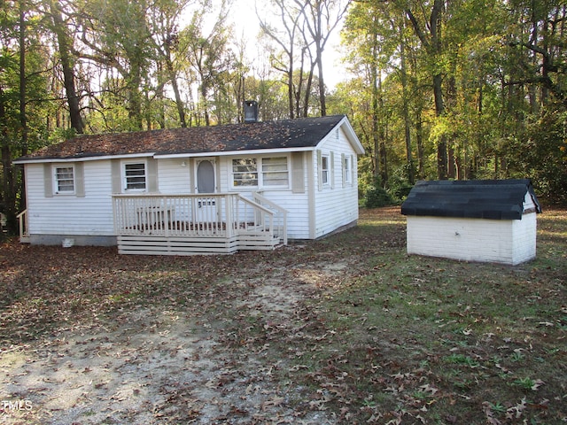 view of front of house featuring a shed and a wooden deck