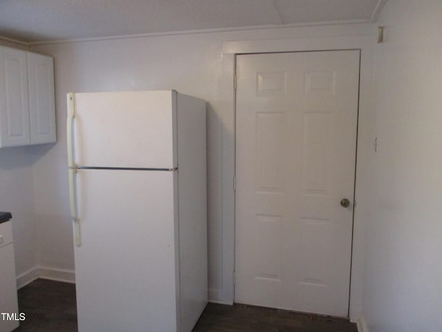 kitchen with white cabinetry and white refrigerator