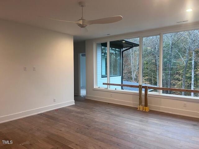 spare room with hardwood / wood-style flooring and ceiling fan