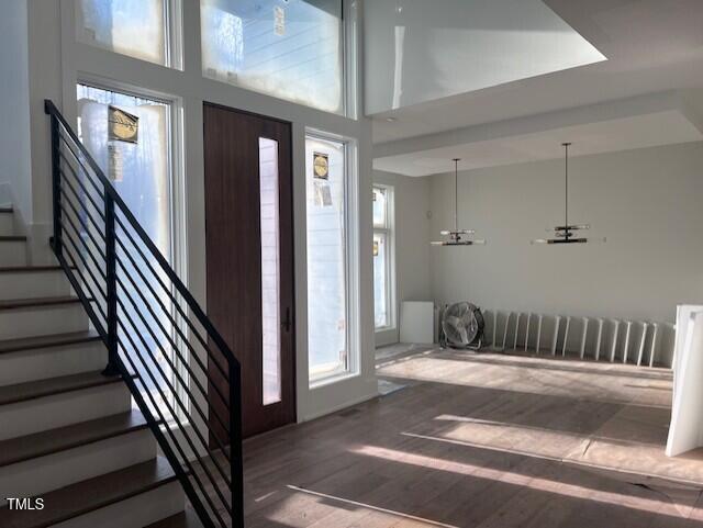 foyer featuring a high ceiling and hardwood / wood-style floors