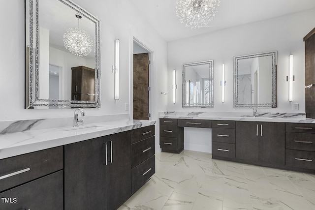 bathroom with vanity and an inviting chandelier