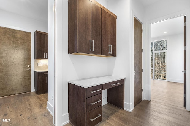 hallway with hardwood / wood-style flooring