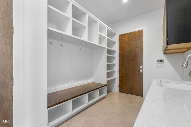 mudroom featuring sink and light tile patterned floors