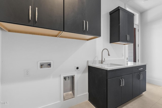 laundry room featuring sink, light tile patterned floors, electric dryer hookup, cabinets, and washer hookup