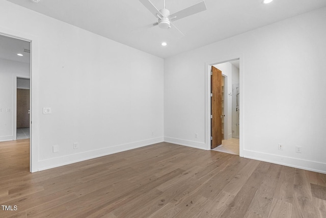 empty room with light hardwood / wood-style floors and ceiling fan