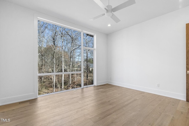 spare room featuring ceiling fan and light hardwood / wood-style floors