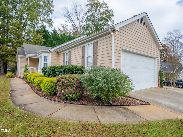 view of side of home featuring a garage