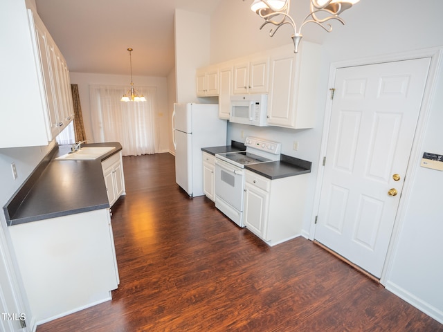 kitchen featuring dark wood-type flooring, white cabinets, a notable chandelier, pendant lighting, and white appliances