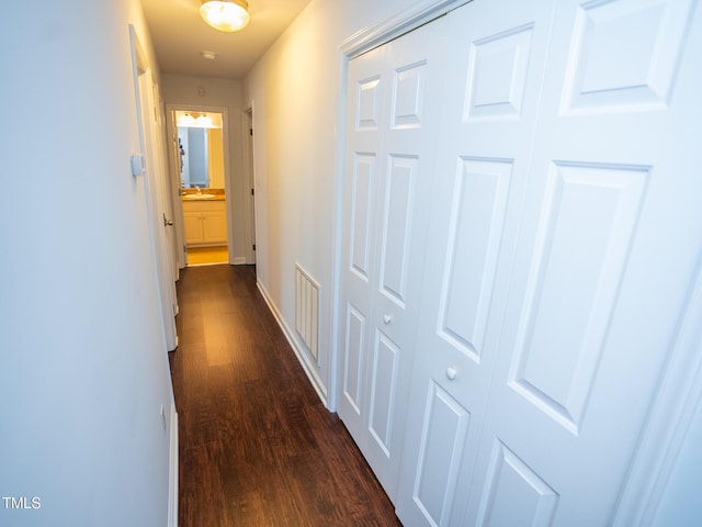 6220 Sweden Dr, Raleigh, NC 27612 - hallway featuring dark wood finished floors and baseboards