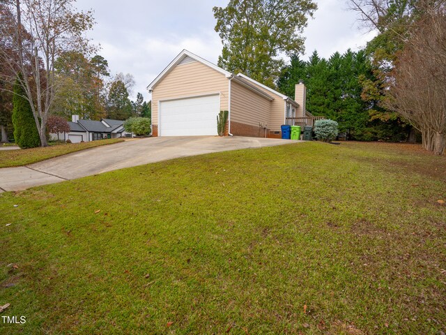 view of front of home with a garage and a front lawn