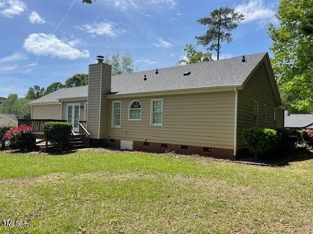 6220 Sweden Dr, Raleigh, NC 27612 - back of house featuring crawl space, a lawn, a deck, and a chimney