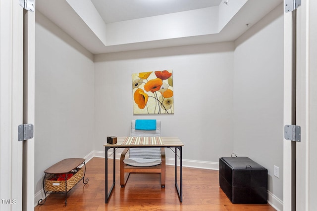 office space featuring hardwood / wood-style floors and a skylight