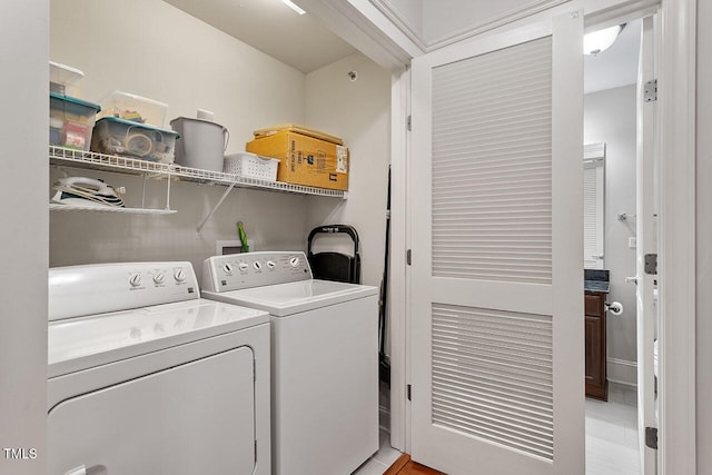 laundry room featuring light wood-type flooring and separate washer and dryer