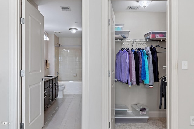 full bathroom featuring vanity, tiled shower / bath combo, and toilet