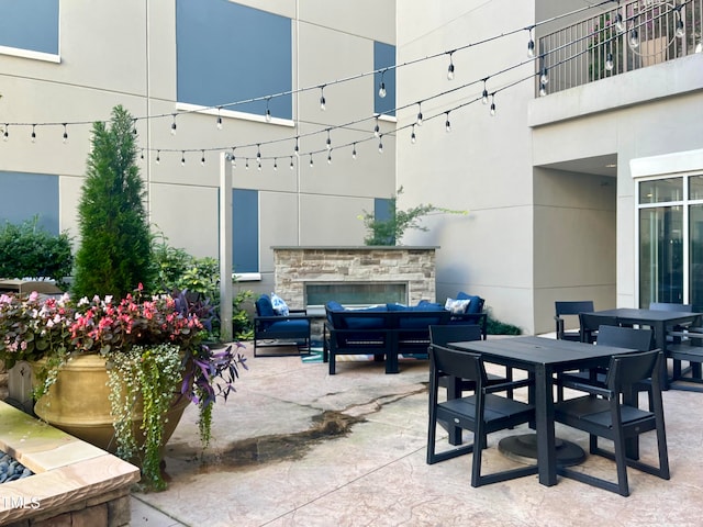 view of patio / terrace with an outdoor living space with a fireplace