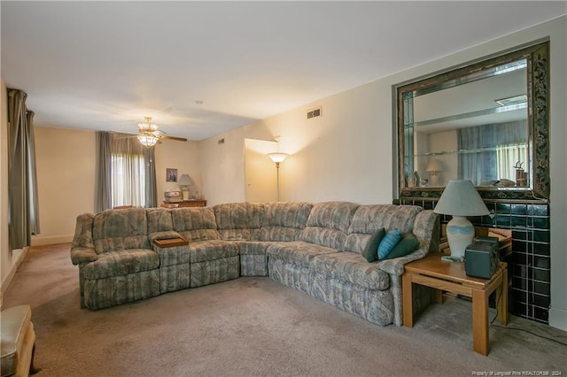 living room featuring carpet and ceiling fan