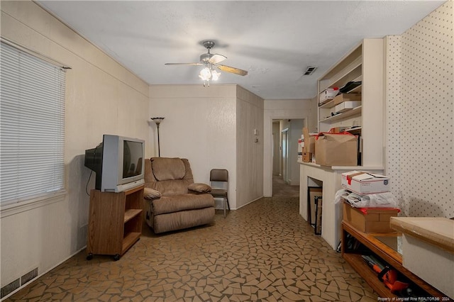 sitting room featuring ceiling fan