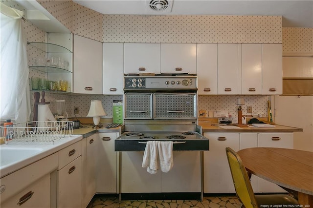 kitchen with white cabinetry and decorative backsplash