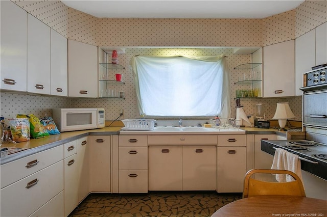 kitchen with white cabinetry and sink