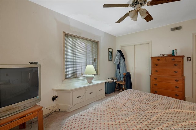 bedroom featuring ceiling fan, a closet, and light colored carpet