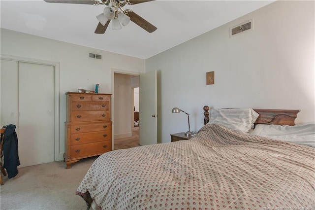 carpeted bedroom featuring a closet and ceiling fan