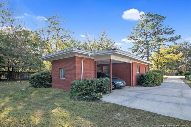 view of side of home featuring a lawn and a carport