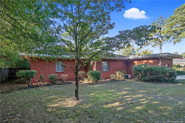 view of property exterior featuring a lawn and central AC