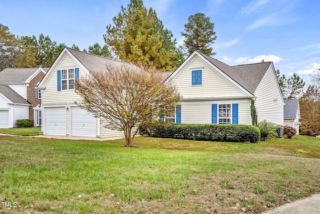 view of front facade with a front yard and a garage