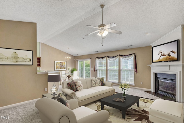 living room with light colored carpet, ceiling fan with notable chandelier, a textured ceiling, and lofted ceiling