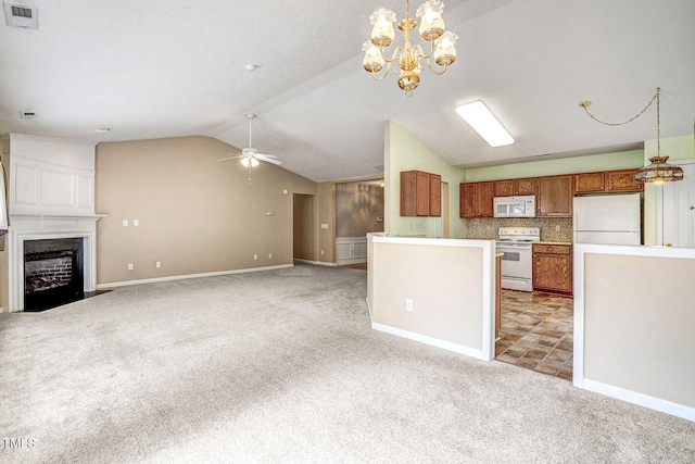 kitchen featuring hanging light fixtures, light carpet, and white appliances