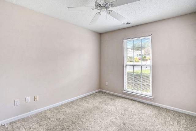 carpeted empty room with a textured ceiling and ceiling fan