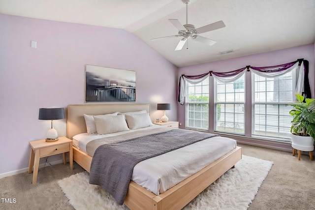 bedroom featuring ceiling fan, vaulted ceiling, and light colored carpet